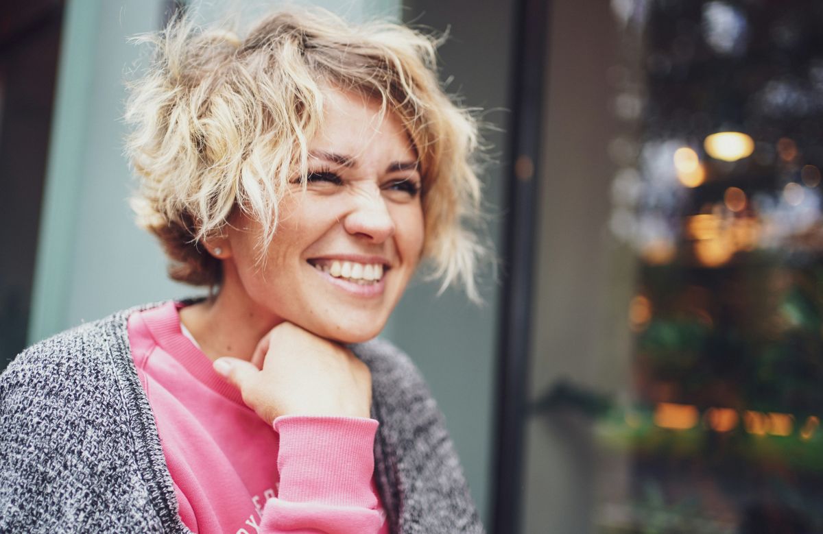 Confident woman smiling in soft natural light during menopause